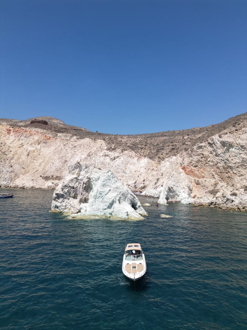 The Athena Volcano Cruises Sea Ray 33 private speedboat anchored at White Beach, Santorini